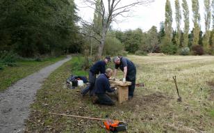 Group of volunteers install a bench