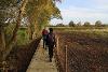 Two people walking on a boardwalk on Kett's Trail.
