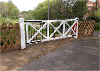 View of the level crossing gates marking the start of the Marriott's Way route at Barn Road.