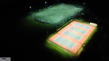 Night time aerial view of Kett's Park floodlit 3G football pitch, tennis and netball courts, looking south-west. (Photo by Tim Mansfield)