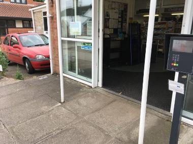 Exterior view of the entrance to Diss library with the 'open access' key pad.