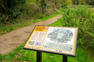 Information board at Cringleford Meadow with maps and text, next to a footpath. (Photo by Fisheye)