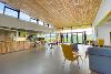 Interior photograph of the cafe at The Nest, with the Norfolk Hire Area visible outside.
