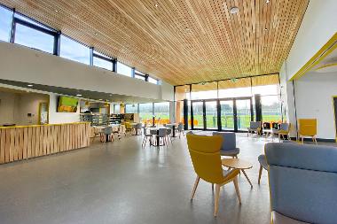 Interior photograph of the cafe at The Nest, with the Norfolk Hire Area visible outside.
