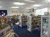 Interior photograph of Harleston library with shelves of books and displays.