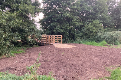 A newly constructed wooden footbridge over a ditch at East Wymondham.