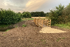 A newly constructed wooden footbridge over an open ditch at East Wymondham.