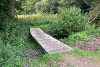 A wooden footbath bridging a shallow ditch at East Wymondham.