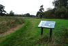 Meadows and an information board at Frenze Beck.