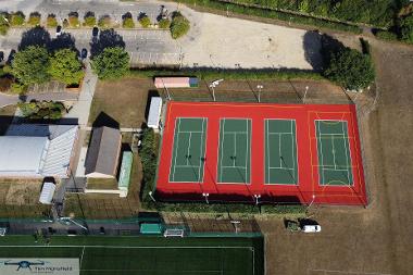 Aerial photograph, directly overhead the tennis courts at Kett's Park, with the club house and paring to the left. (Photo by Tim Mansfield)