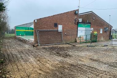 Exterior view of Crusaders Rugby Club with half the roof off and an external wall removed.