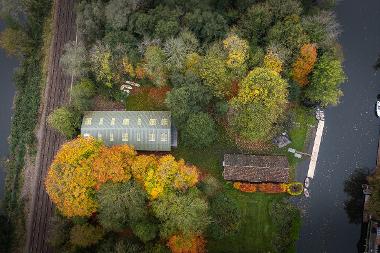 Aerial photograph overhead the Yare Boat Club showing both the new and old boathouses, the River Yare on both side, and the railways line at the rear of the club. (Photo by Fisheye)