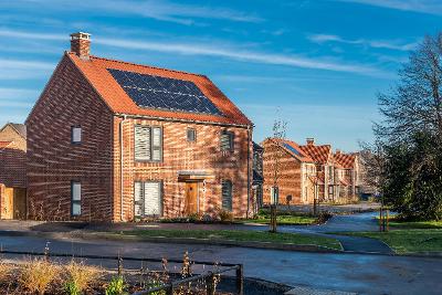 A group of newly-built houses with solar panels on the roof.