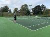 A man preparing to receive a serve on a tennis court.