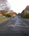 A view of the road through Eaton, with a left hand turn and straight on lane.