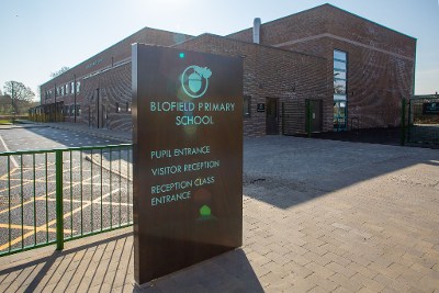 An image of Blofield Primary School's entrance and signage.