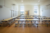 An image of the canteen / hall at Blofield Primary School. The image shows tables set out in the food hall.